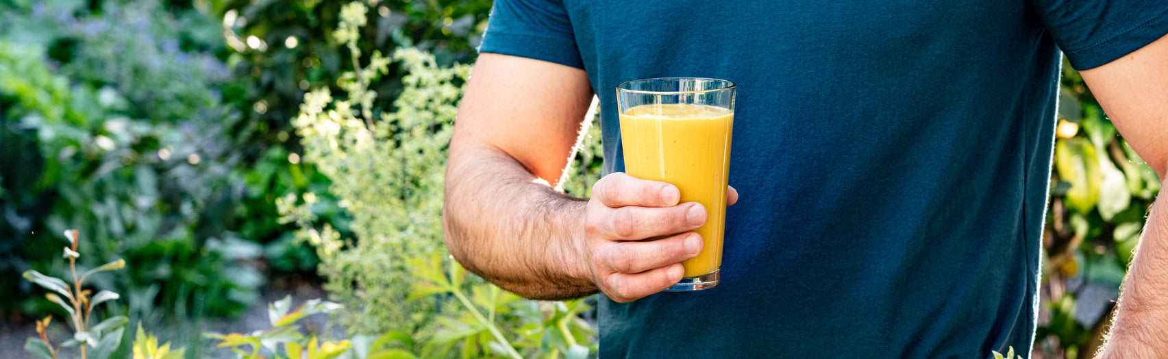 2. Athletic man holding turmeric protein shake