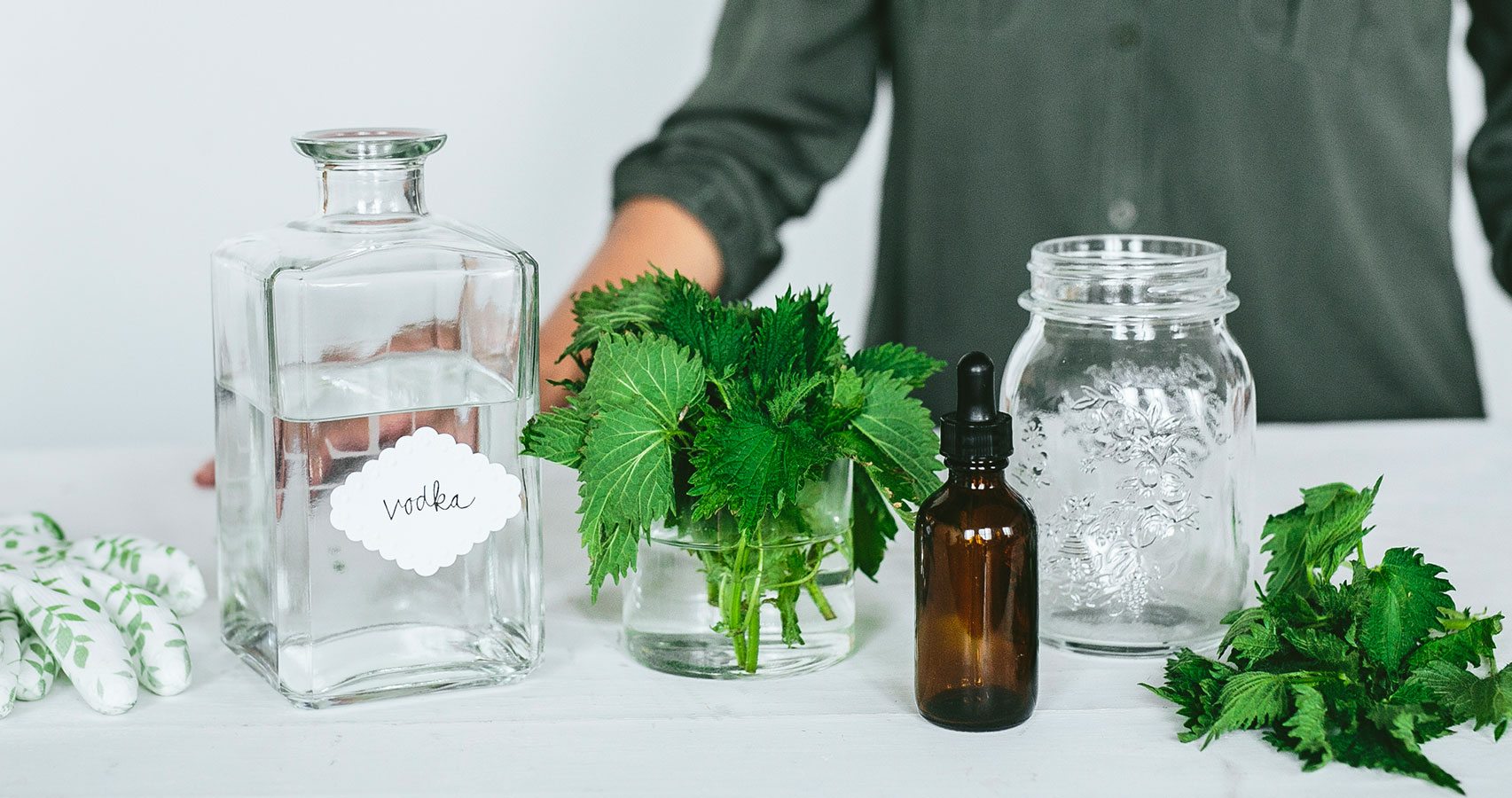 clear bottles with vodka and herbs