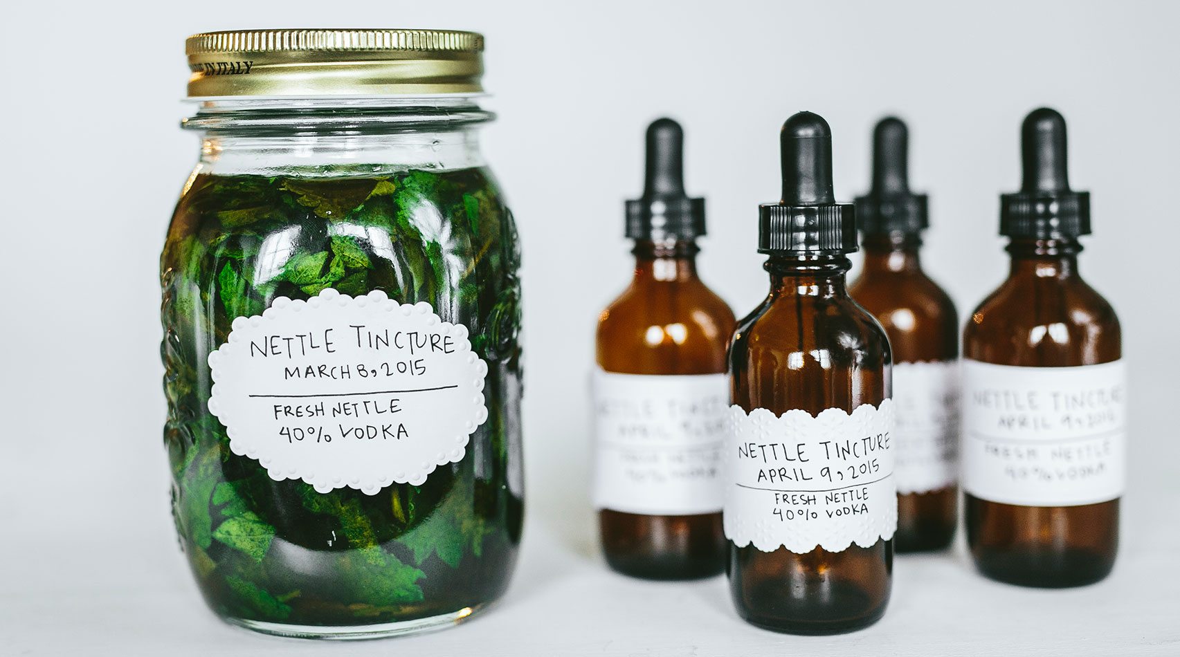 nettle tincture jar and dosage bottles