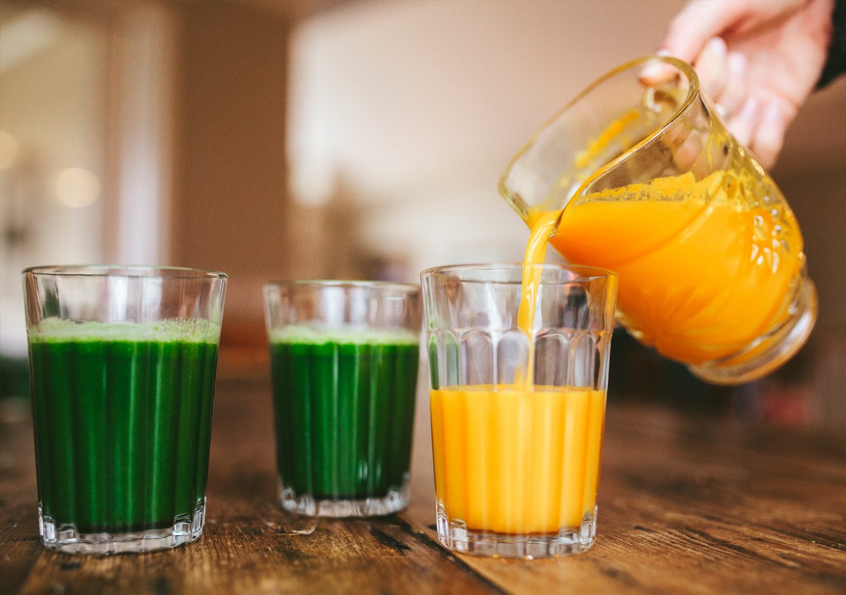 pouring orange herbal juice