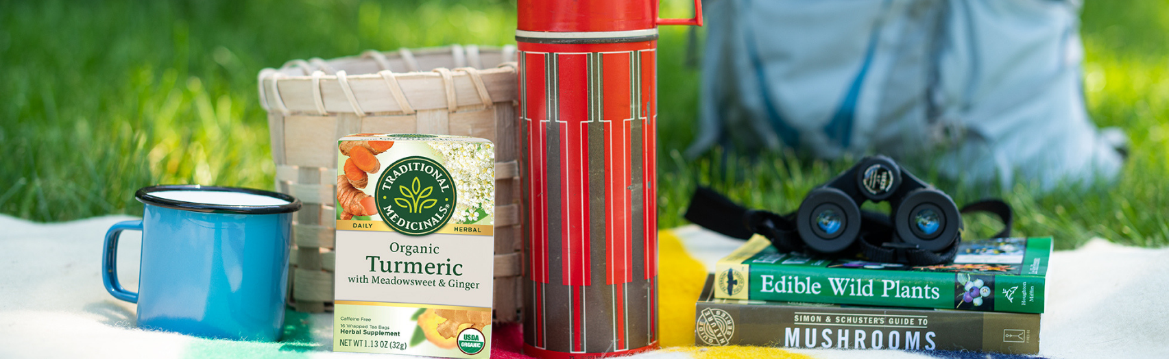 Turmeric with Meadowsweet & Ginger tea next to summer camping essentials